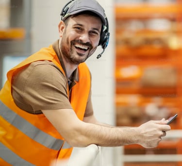 An ecommerce employee smiling in a warehouse