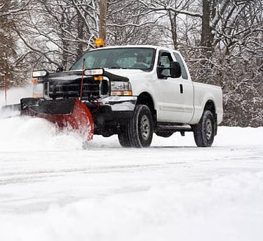 removing snow with plow