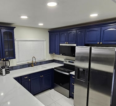 a kitchen with a refrigerator, microwave, and oven