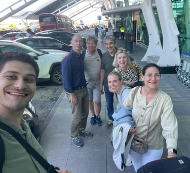 a group of people standing around a luggage carton