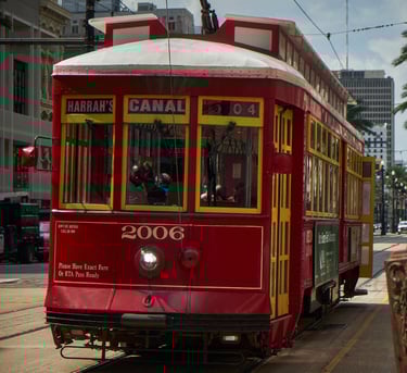 In New Orleans USA, a red trolley car on a city street