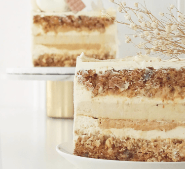 a cake with a white frosting and a flower
