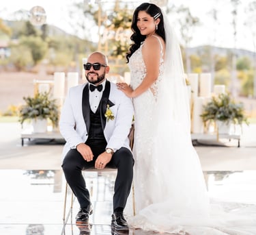 a bride and groom sitting on a chair in a wedding ceremony