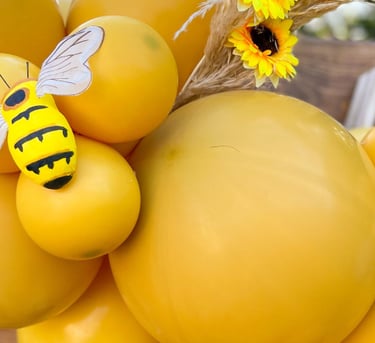 a bunch of balloons and balloons with bees photo backdrop event designer