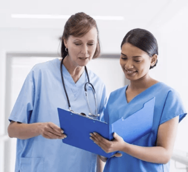 Two nurses working collaboratively. 