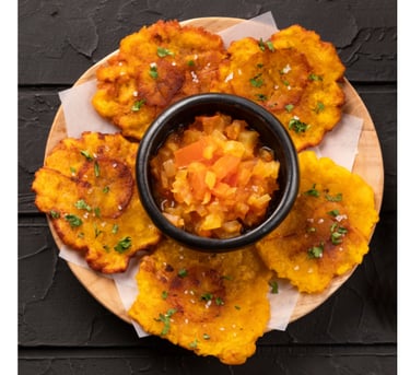 Plate of Puerto Rican tostones with garlic cilantro dipping sauce 