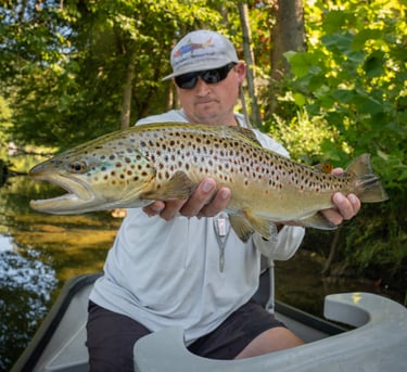 Guide Joe Kostura with an August brown trout