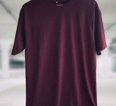 a plain maroon t-shirt displayed on a hanger