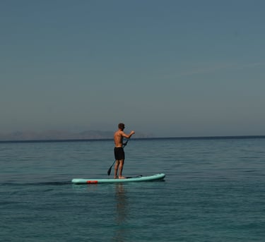  Person paddleboarding on calm waters off the coast of Alcudia
