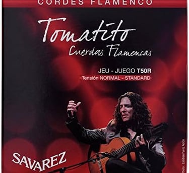 a man playing guitar in front of a microphone