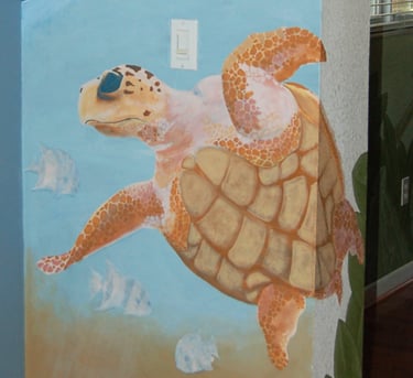 Interior wall mural of a sea turtle swimming with fish in six feet of water near St Pete Beach, FL
