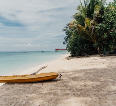 a yellow canoe sitting on the beach