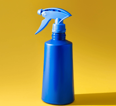 a blue spray bottle on a yellow background