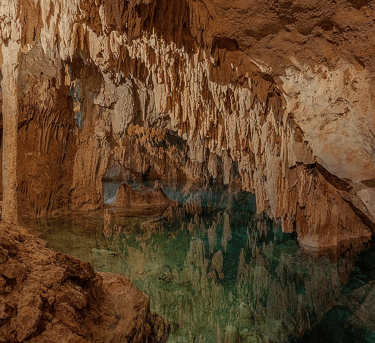 Magical cenote cave with turquoise water and dramatic stalactites in Tulum, Mexico – sacred space fo