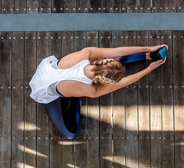 Fashion photography - a woman in a white tank top and blue leggings