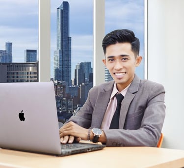 a man in a suit and tie is smiling and holding a laptop