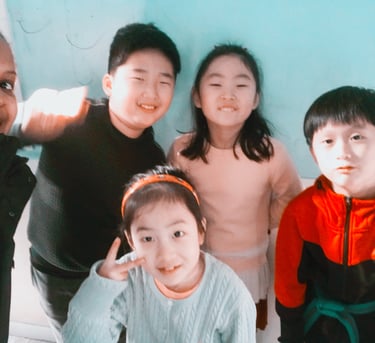 Emmy standing with 4 learners