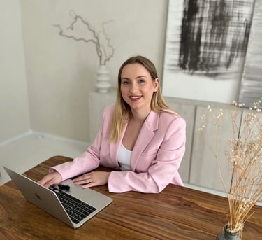 a woman sitting at a table with a laptop
