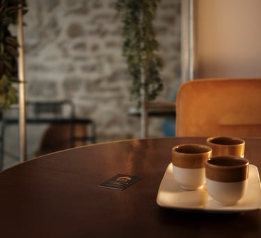 Real Estate ERA picture of three cups of coffee on a table with a plant in the background
