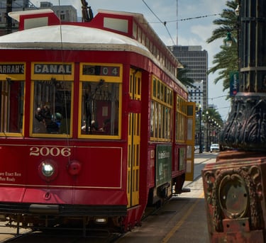 In New Orleans USA, a red trolley car on a city street