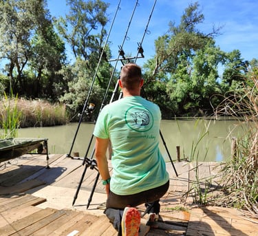 a man is fishing on a dock with a fishing rod