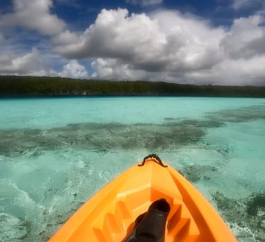 a kayak in the water with a view of a boat
