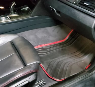 a car with a black leather seat and red trim