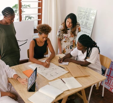 Group of multicultural women in a meeting setting strategic accountability and business goals