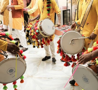 a group of men in traditional indian garb playing drums