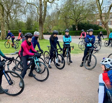 Liz Hughes coaching a group of women on road bikes