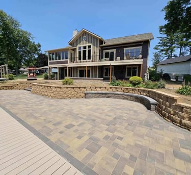 A custom paver patio, retaining wall, and bench by Kingdom Landscape in Heritage Lake Indiana