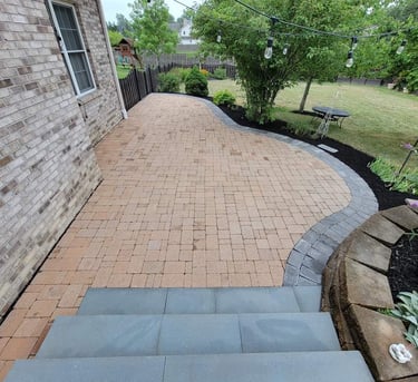 Custom curved back yard patio and retaning wall