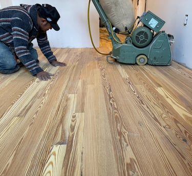 a man is using a machine to remove wood flooring