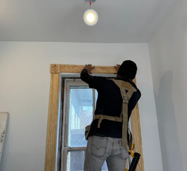 a man is standing on a ladder and holding a light bulb