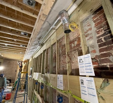 a man standing in a room with a ladder and a ladder