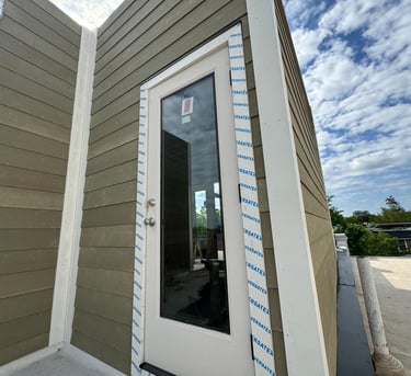 a door to a house with a white door and a blue sky