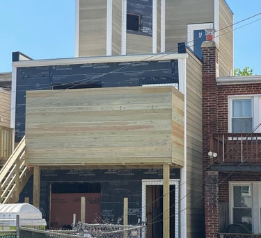 a house with a large wooden deck and a fenced in area