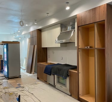a kitchen with a refrigerator and cabinets in the middle of a room