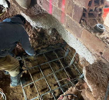 a man is working on a metal grate