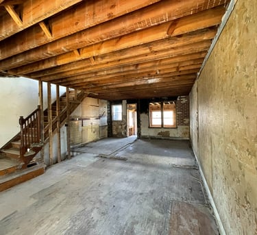 a room with a staircase and stairs leading up to a staircase