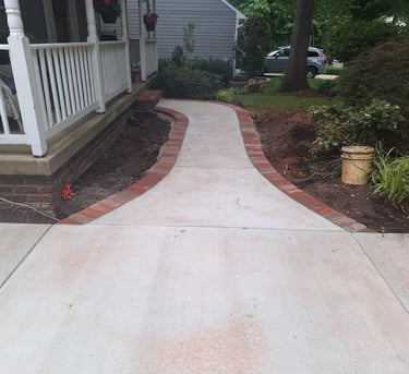 a walkway with a brick walkway and a brick walkway
