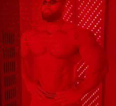 a man with a beard and eye protection on a red light therapy
