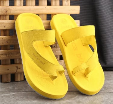 a pair of yellow sandals with a yellow strap