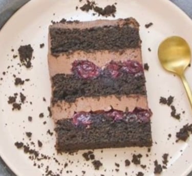 a piece of cake with chocolate frosting on a plate