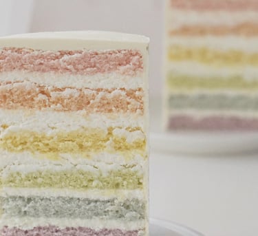 a slice of cake with a rainbow - colored layers