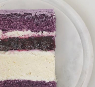 a piece of cake with a purple and white background