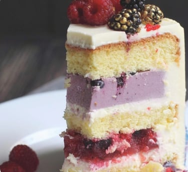 a piece of cake with berries on top of it