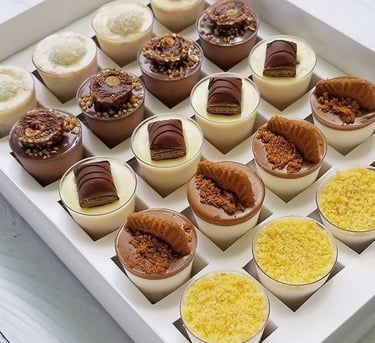 a box of desserts with chocolates and desserts