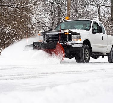 removing snow with plow