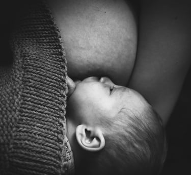 nouveau-né tétant le sein de sa mère couvert par un gilet